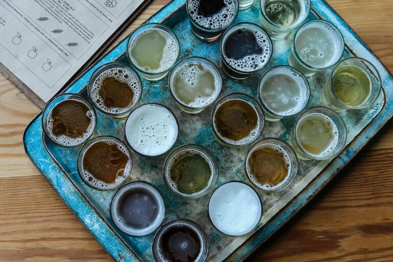 Aerial view of assorted beer glasses on a rustic tray, perfect for brewery tasting sessions.